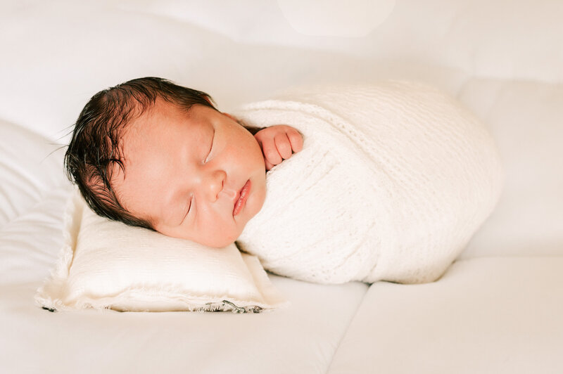 Springfield Mo newborn photographer Jessica Kennedy of The XO Photography captures newborn baby boy swaddled in bed