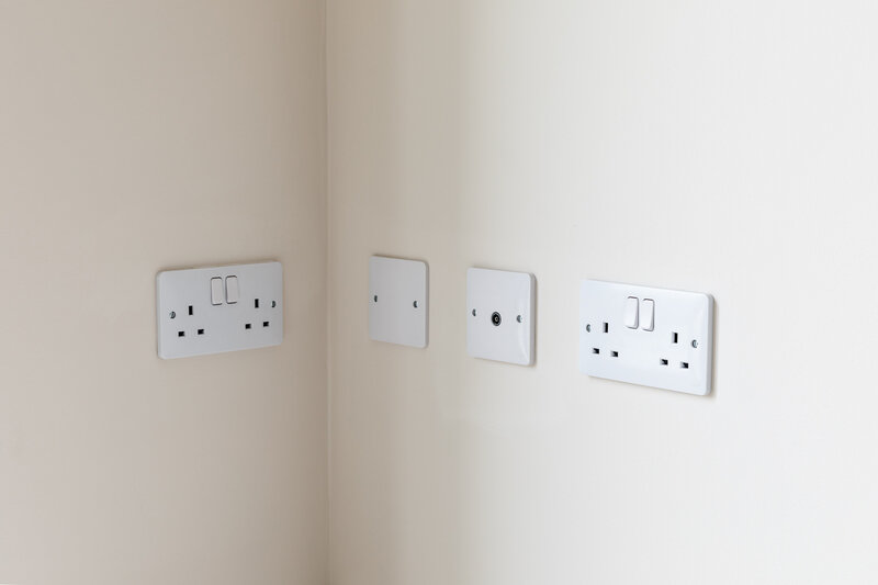 Electrical outlets on blank wall