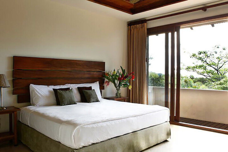 white bed with glass door ocean view room blue spirit costa rica 2