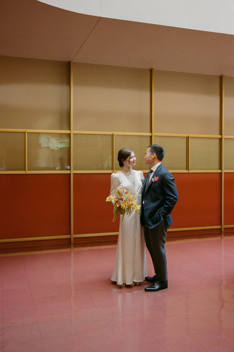 Bride and groom standing together indoors at Marin County Civic Center.