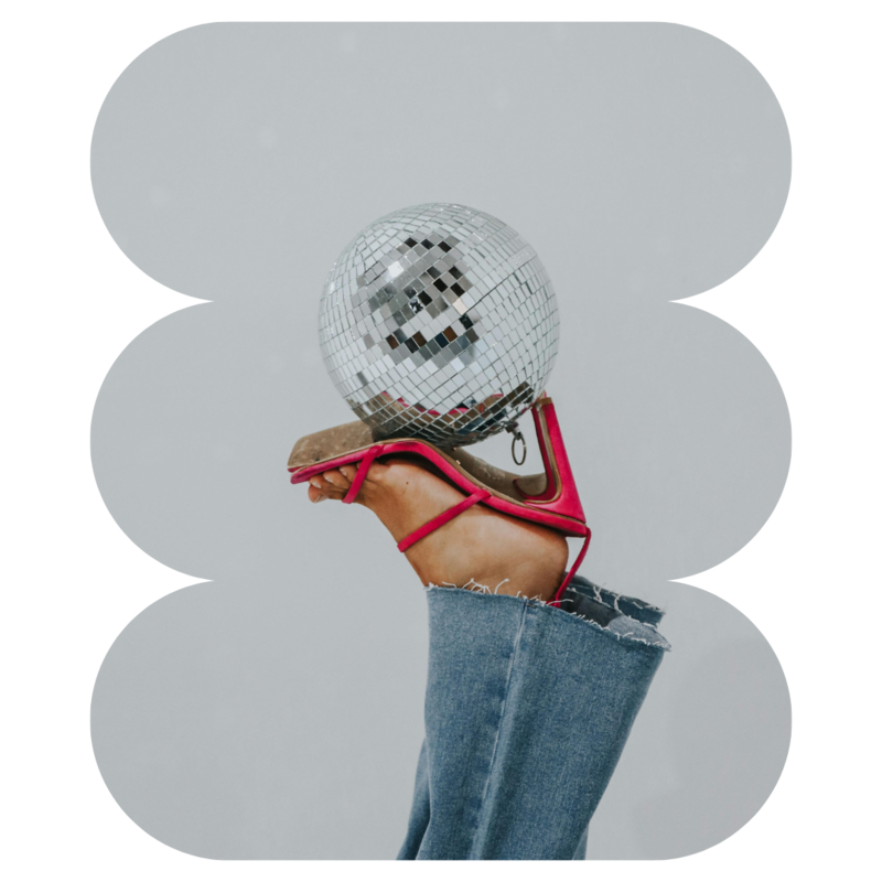 Disco ball being held with hot pink heels