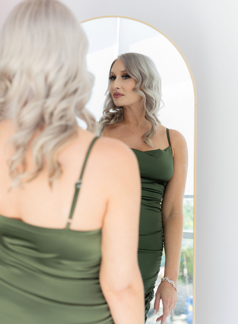 woman looking in mirror