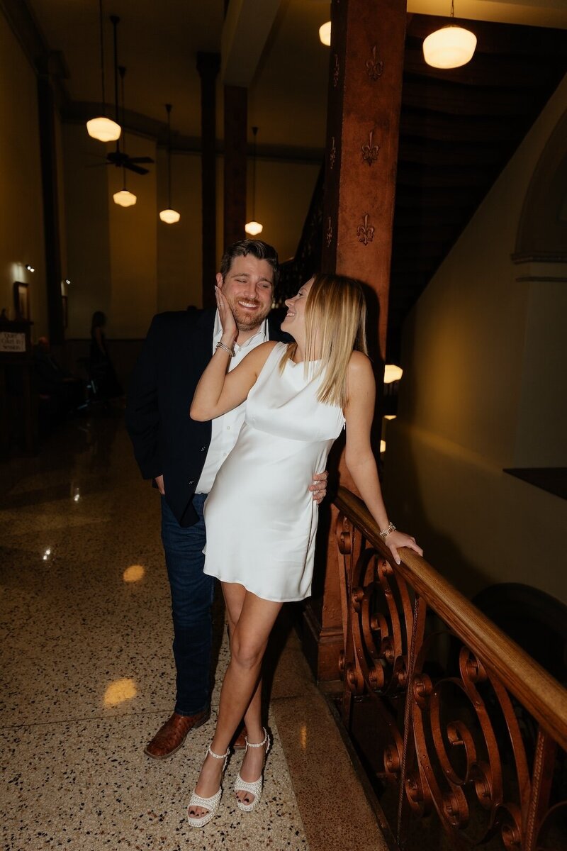 bride holds grooms cheek after courthouse elopement in texas