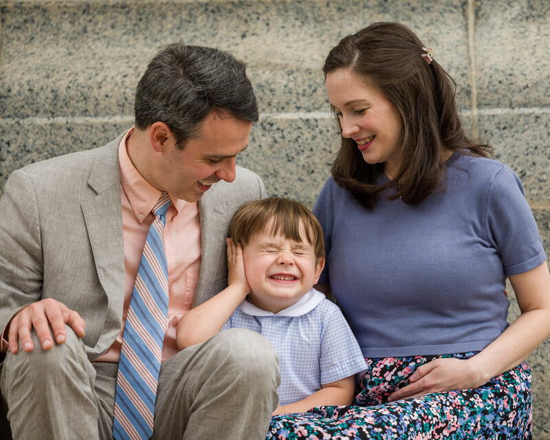 A little boy scrunching his nose playfully during a spring photo session at Valley Forge
