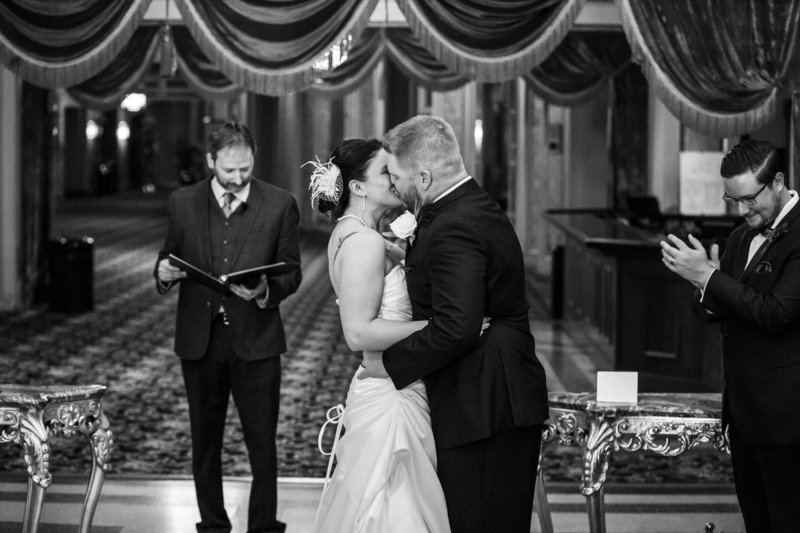 Erie bride and groom share first kiss at their Warner Theatre wedding ceremony