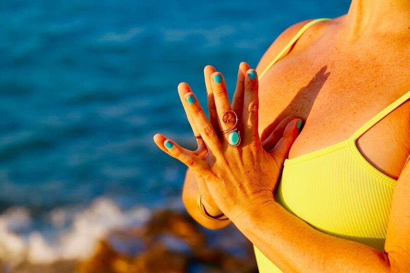 Meditative hand position with calming ocean energy.