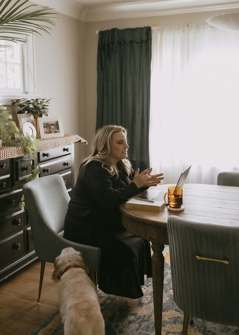 Renee Hoffman sitting at dining room leading therapy session