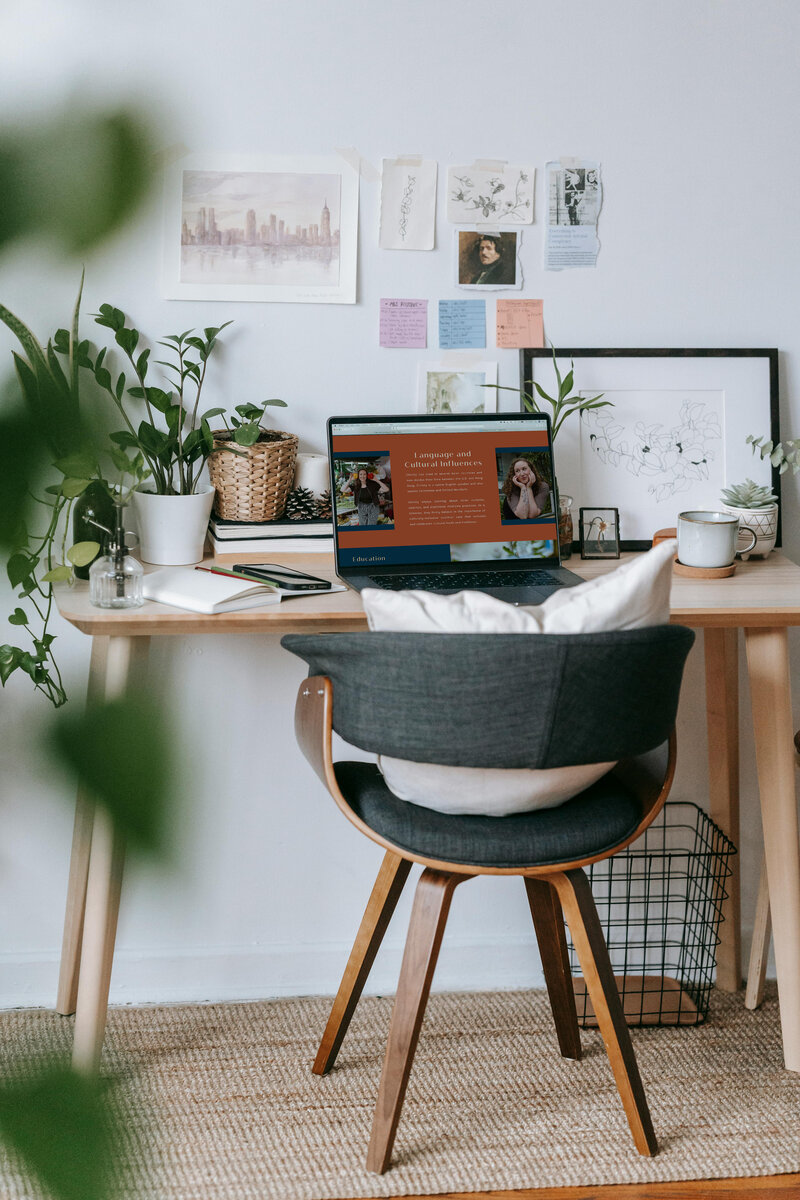 A desk with a laptop and a chair, set against a wall, creating a workspace for a dietitian.