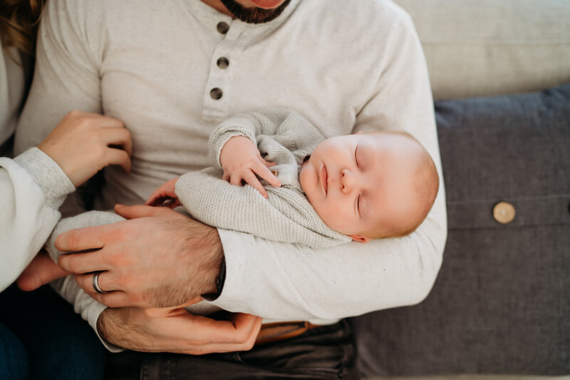 new parents holding their baby in their boston newborn session