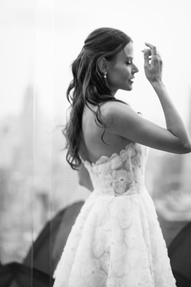 Bride wearing a Dora Sasu reception gown at the Top of the Rockefeller Center