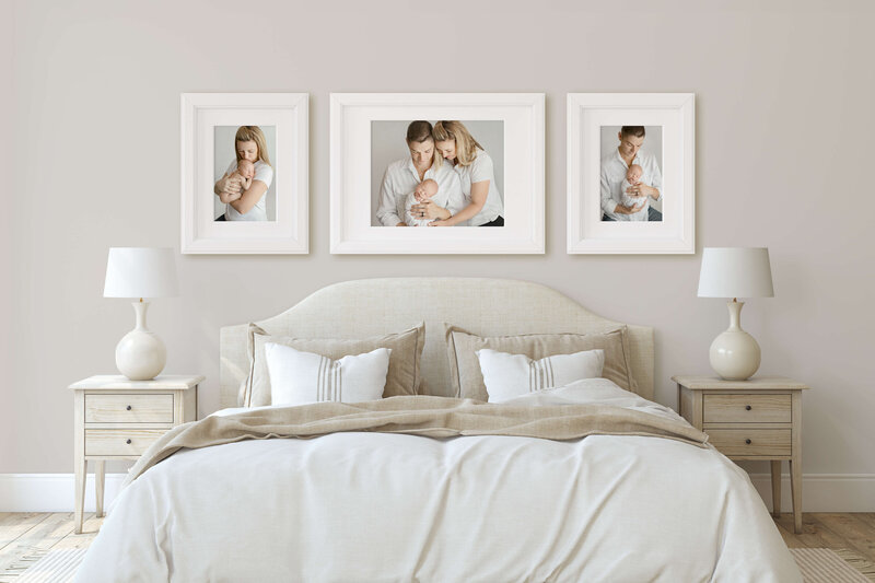 bedroom  with  three  framed  images of parents holding  newborn baby hung above bed