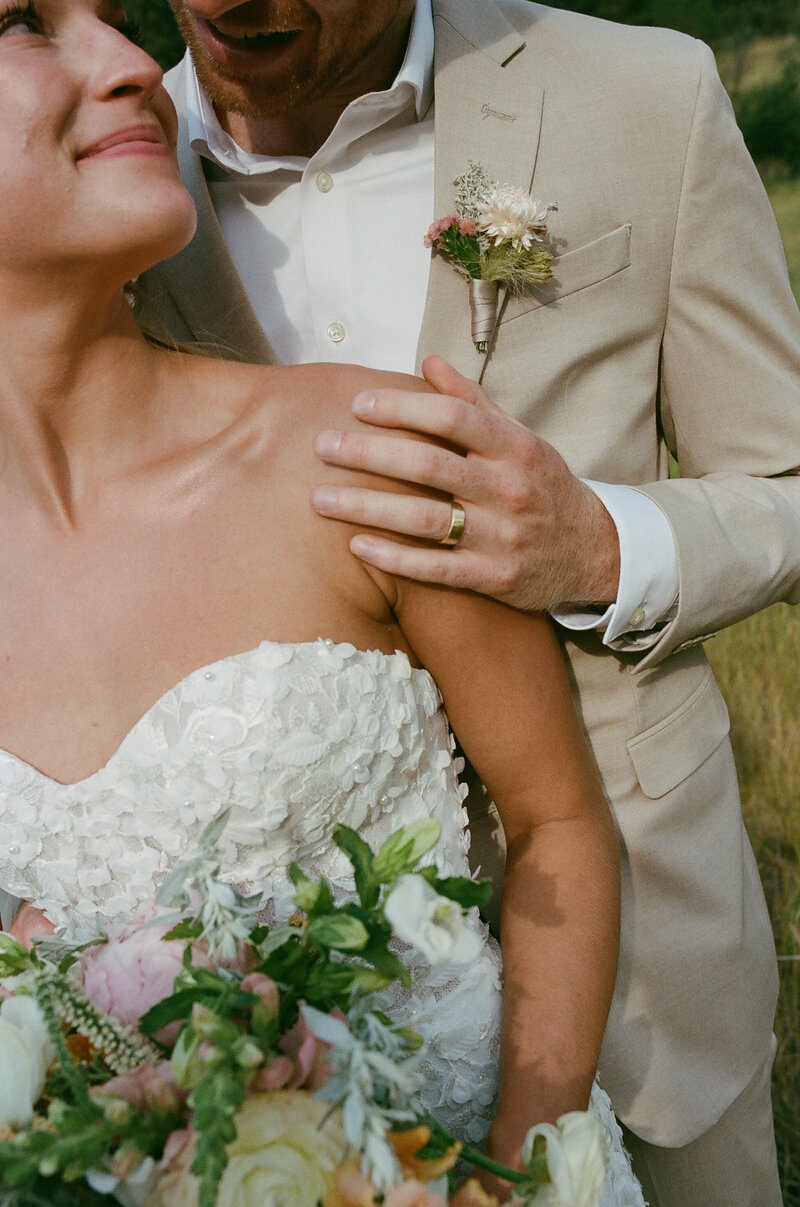 groom resting hand with his ring on the brides soulder
