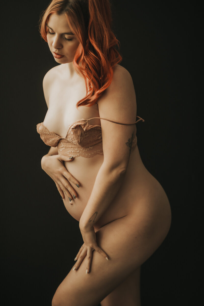 pregnany woman poses in lingerie during boudoir photography shoot in vancouver bc studio
