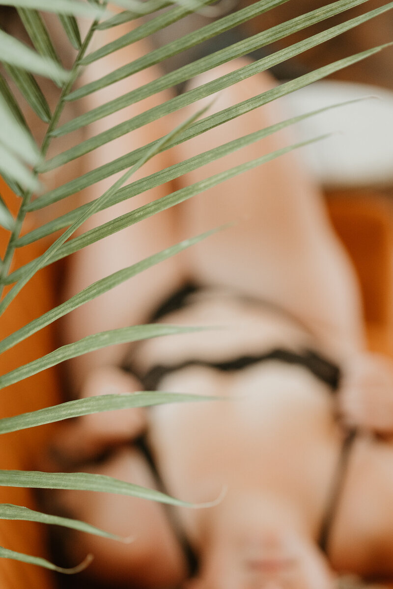woman laying on couch for luxuryboudoir session in studio in Bethlehem PA 