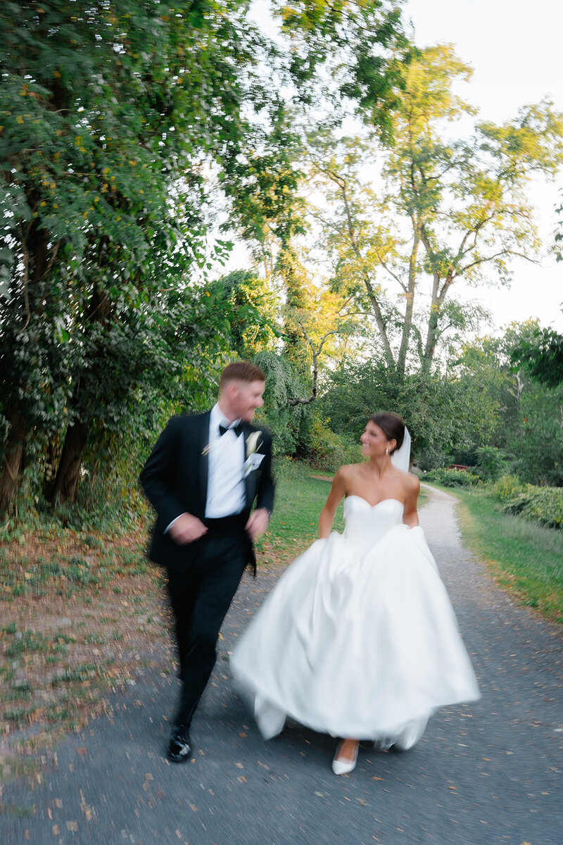 A bride and groom walking and laughing together at their Cape May Winery wedding.