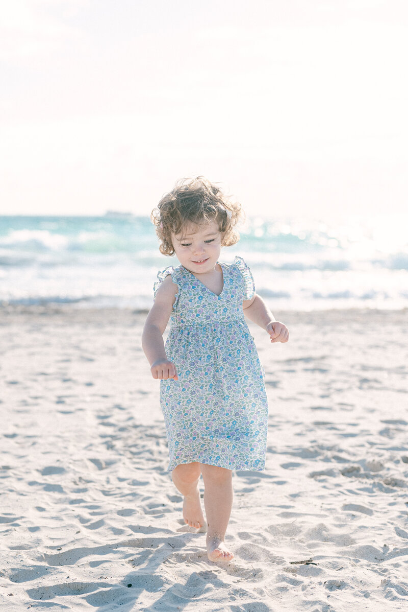Toddler running on the beach