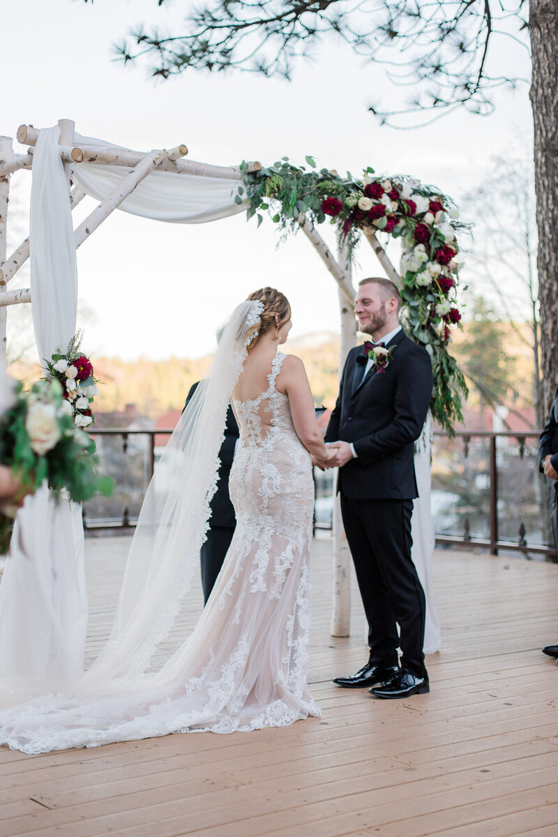 groom side glances at his bride, admiring her beauty