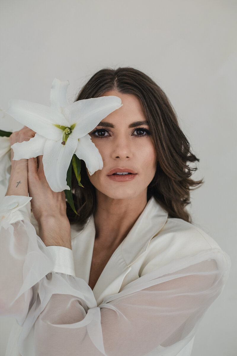 Portrait of woman in studio with a white flower in albuquerque studio.