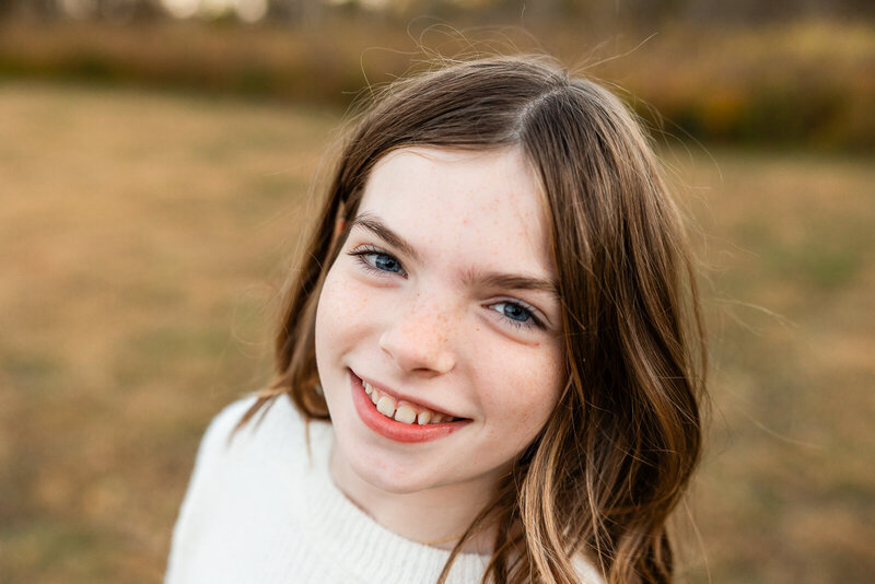 Close up portrait headshot of a girl taken during a family portrait session. 