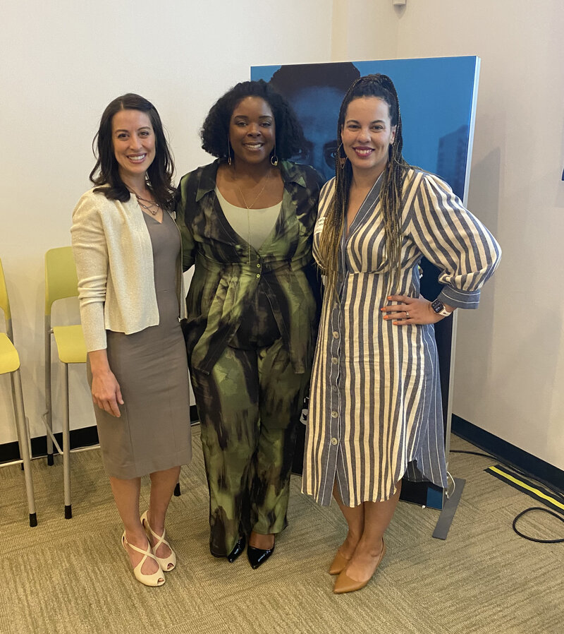 Three women standing posing. 