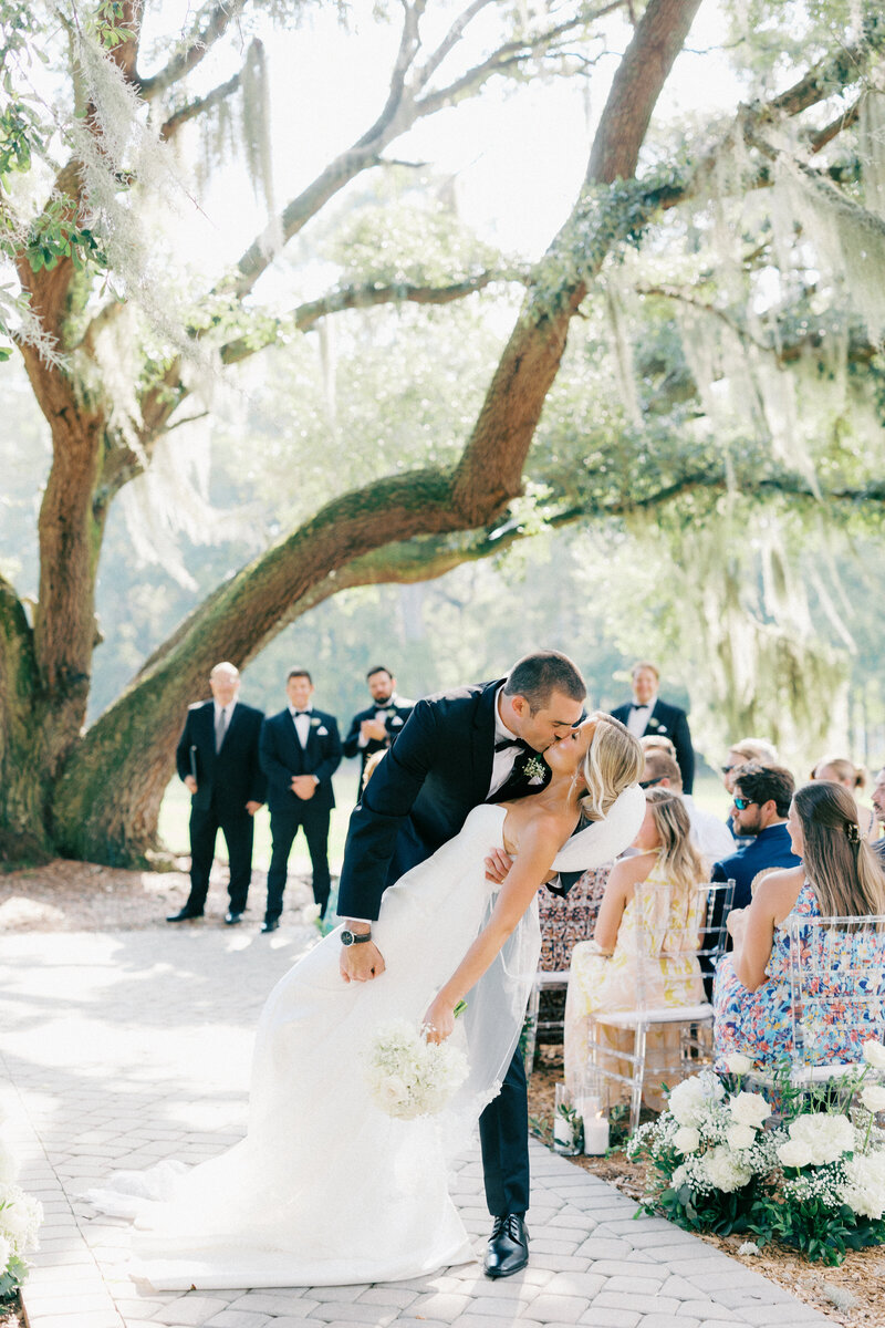 Bride and groom holding onto one another