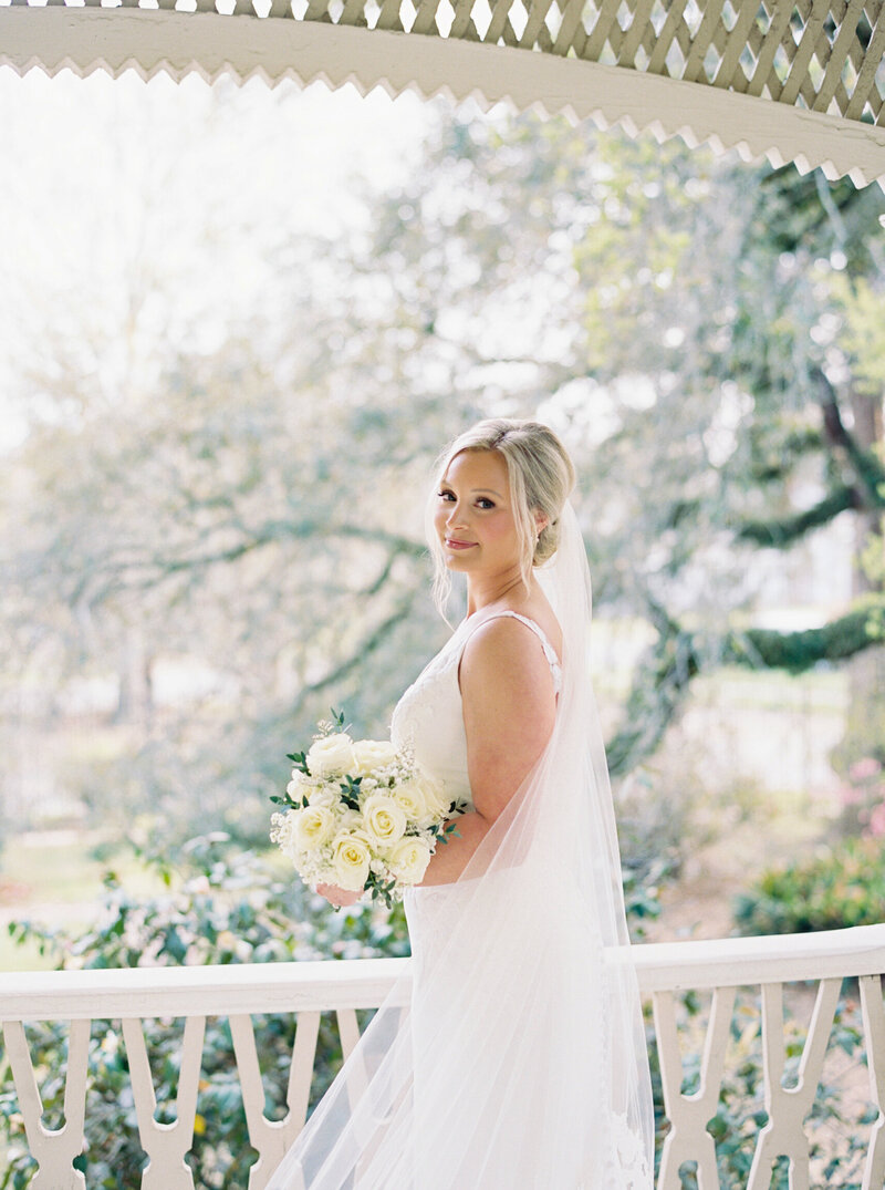 Bride standing gracefully at the historic John Nickerson House, captured in an elegant moment by Morgan Alysse, Louisiana wedding photographer.