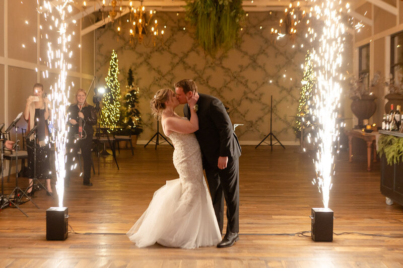 New married couple sweet kiss under the sparkle lights