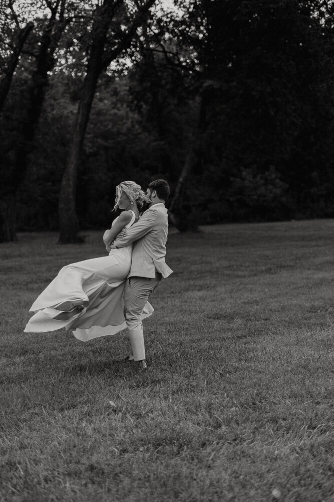 groom swinging bride around