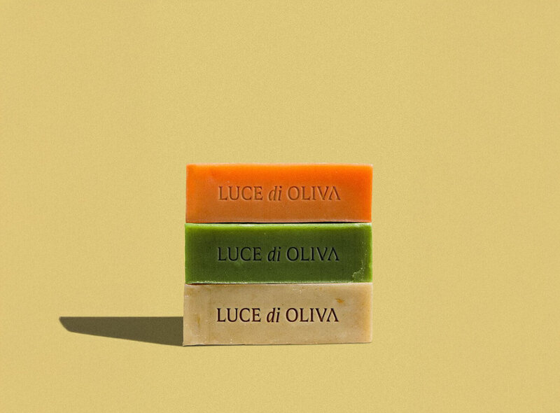  Three colorful Mediterranean olive oil soap bars stacked showing natural skincare products by Luce di Oliva.
