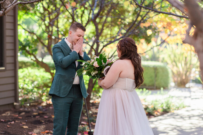 groom admires bride during first look