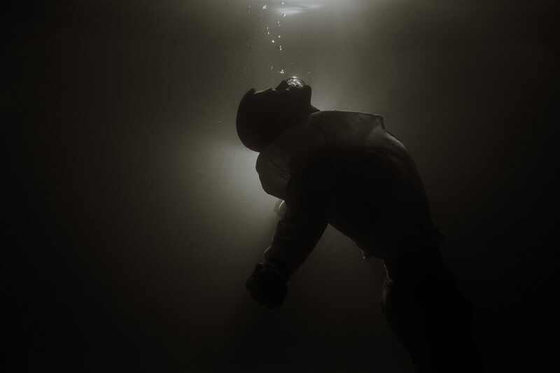 Black and white underwater photo of man