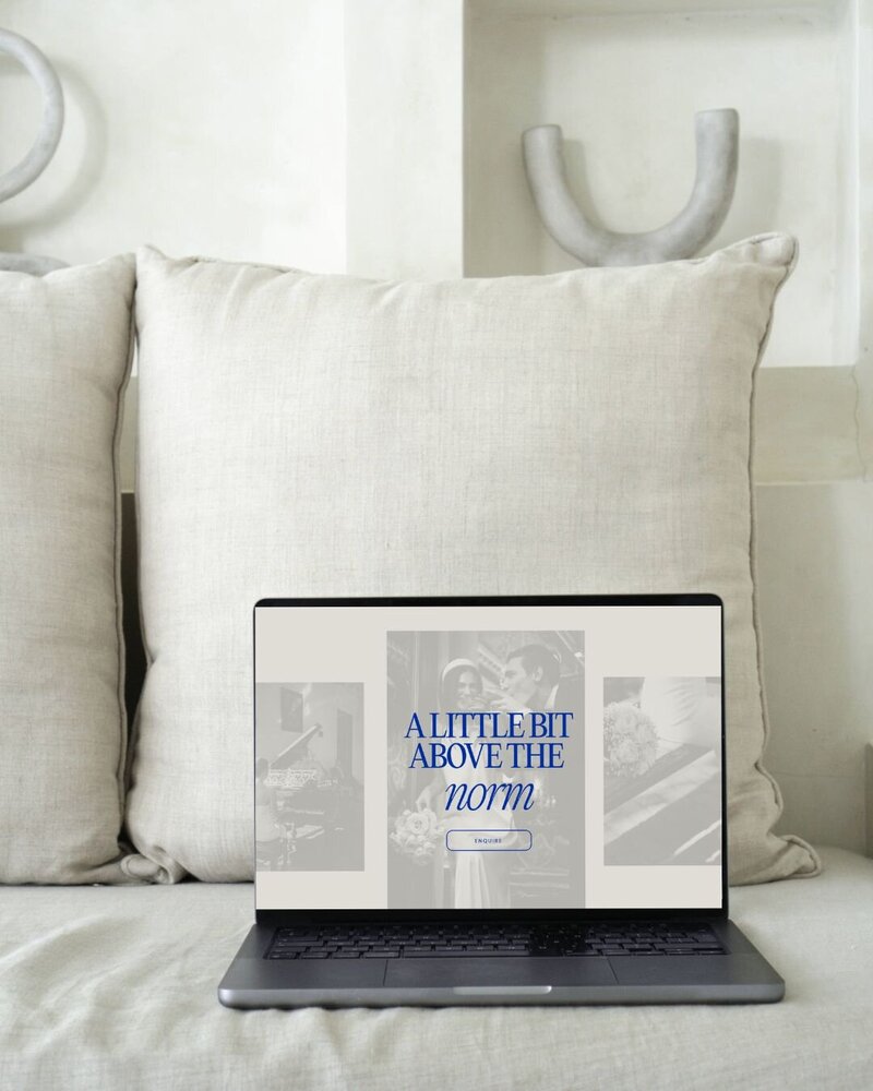 website design for a photographer on a  cream sofa with an aesthetic background.