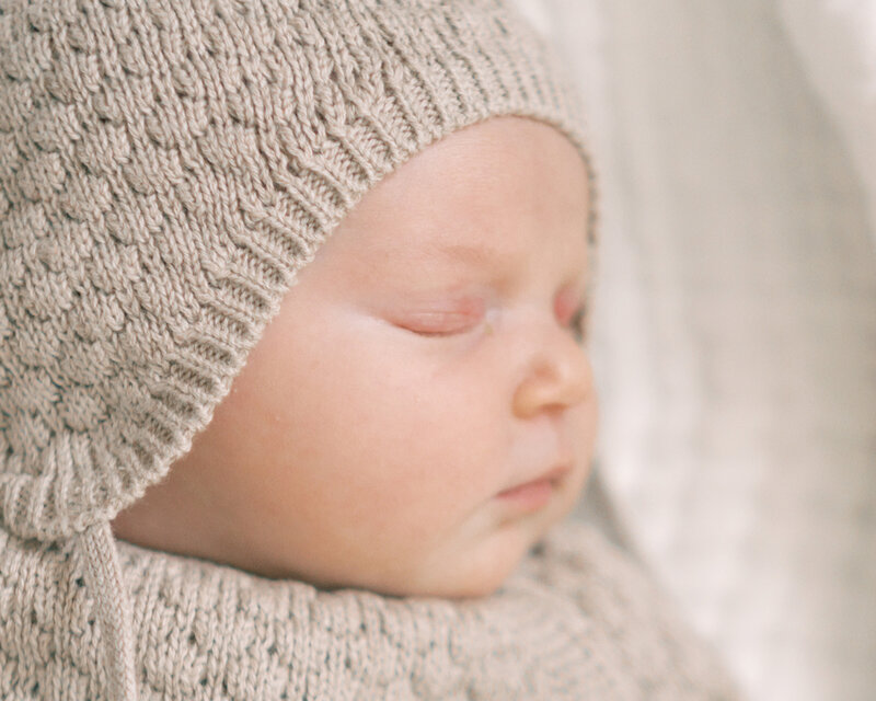 Close up detail shot of newborn baby in a bonnet by Lawton Ok Photographer Courtney Cronin