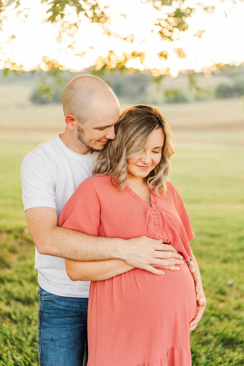 a man hugging his pregnant wife