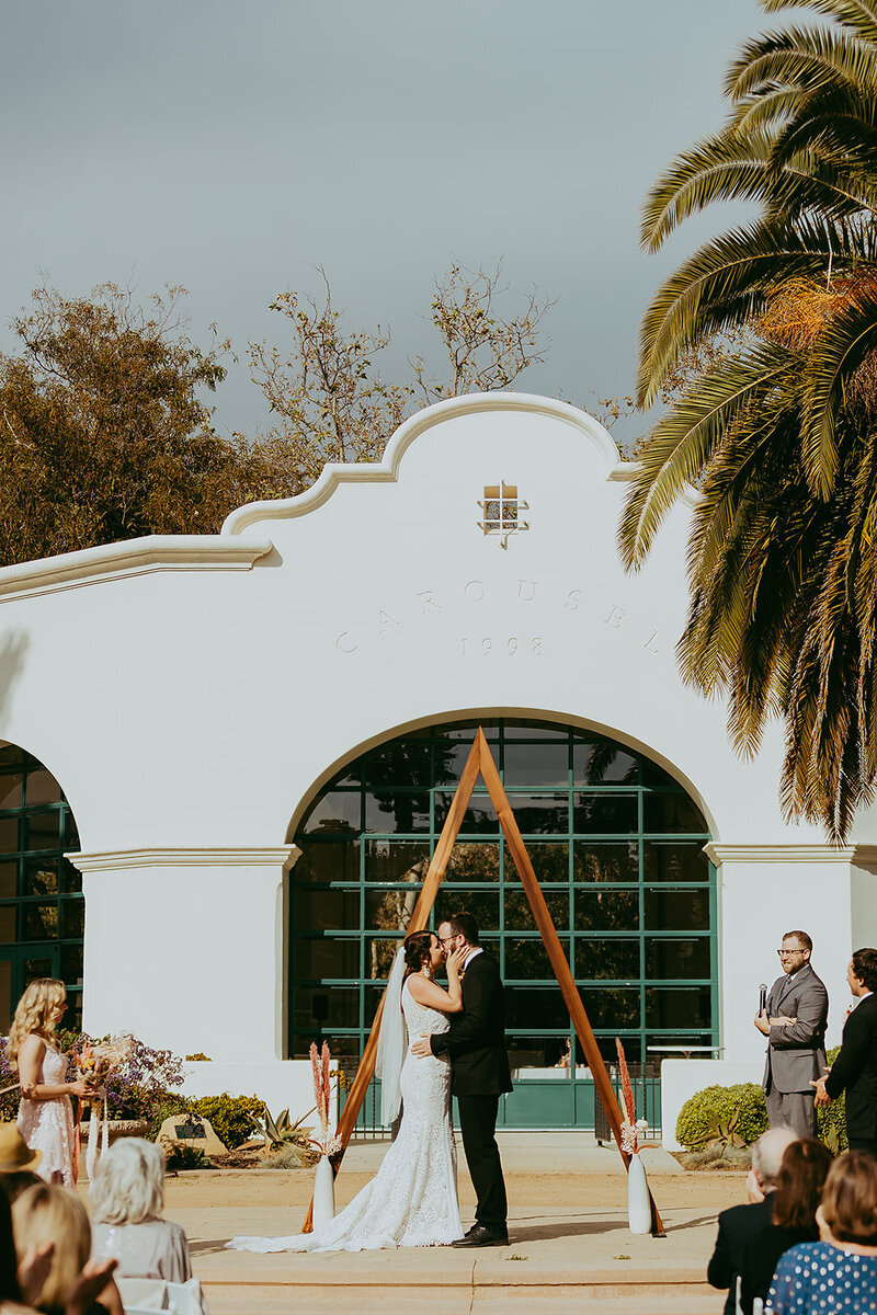 Couple kissing at the alter at Santa Barbara Carousel House captured by White Desert Photography