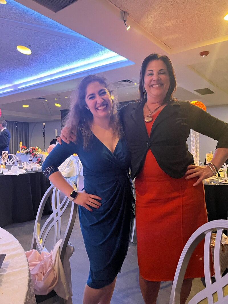 Nicole from Charizma Entertainment posing with a guest at an elegant Chicago event
