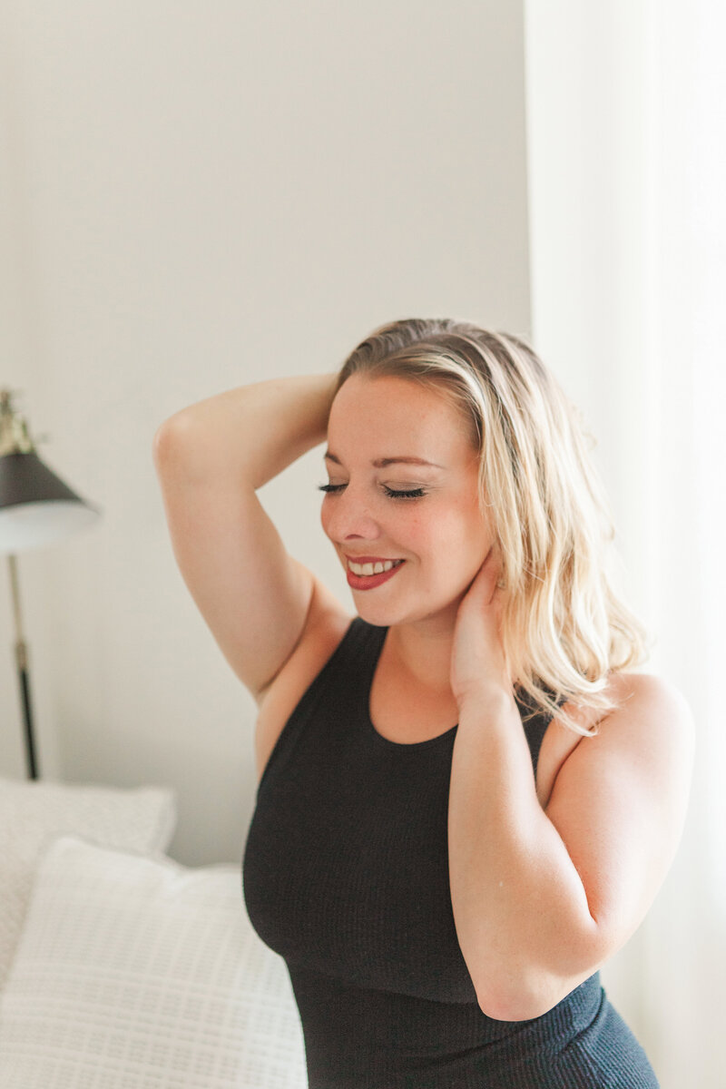 blonde woman in black body suit boudoir