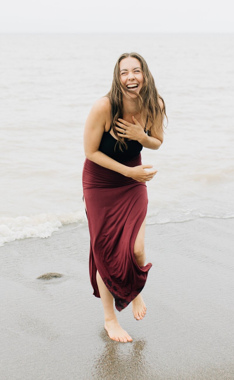 Boss & Buddha Founder Emily Branton laughing on the beach