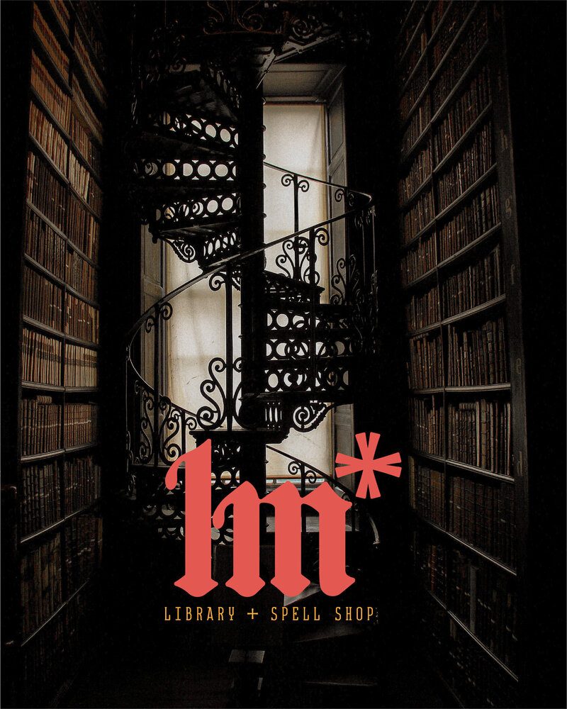 dark academia spiral staircase library with le metier monogram logo