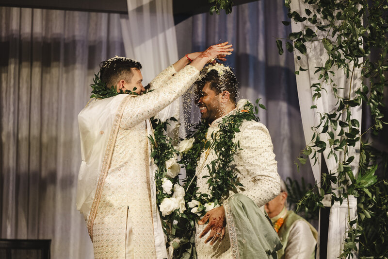 Someone sprinkling rice over their partner's head during their wedding ceremony 