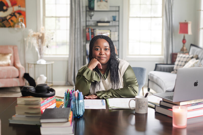 a black woman counselor and astrologer sits at her desk