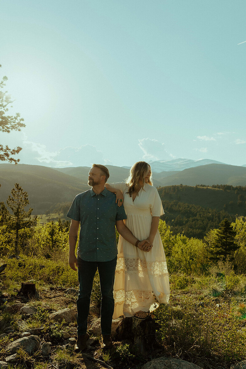 couple holding hands on hill