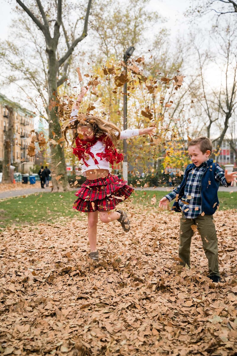 Kids throwing leaves