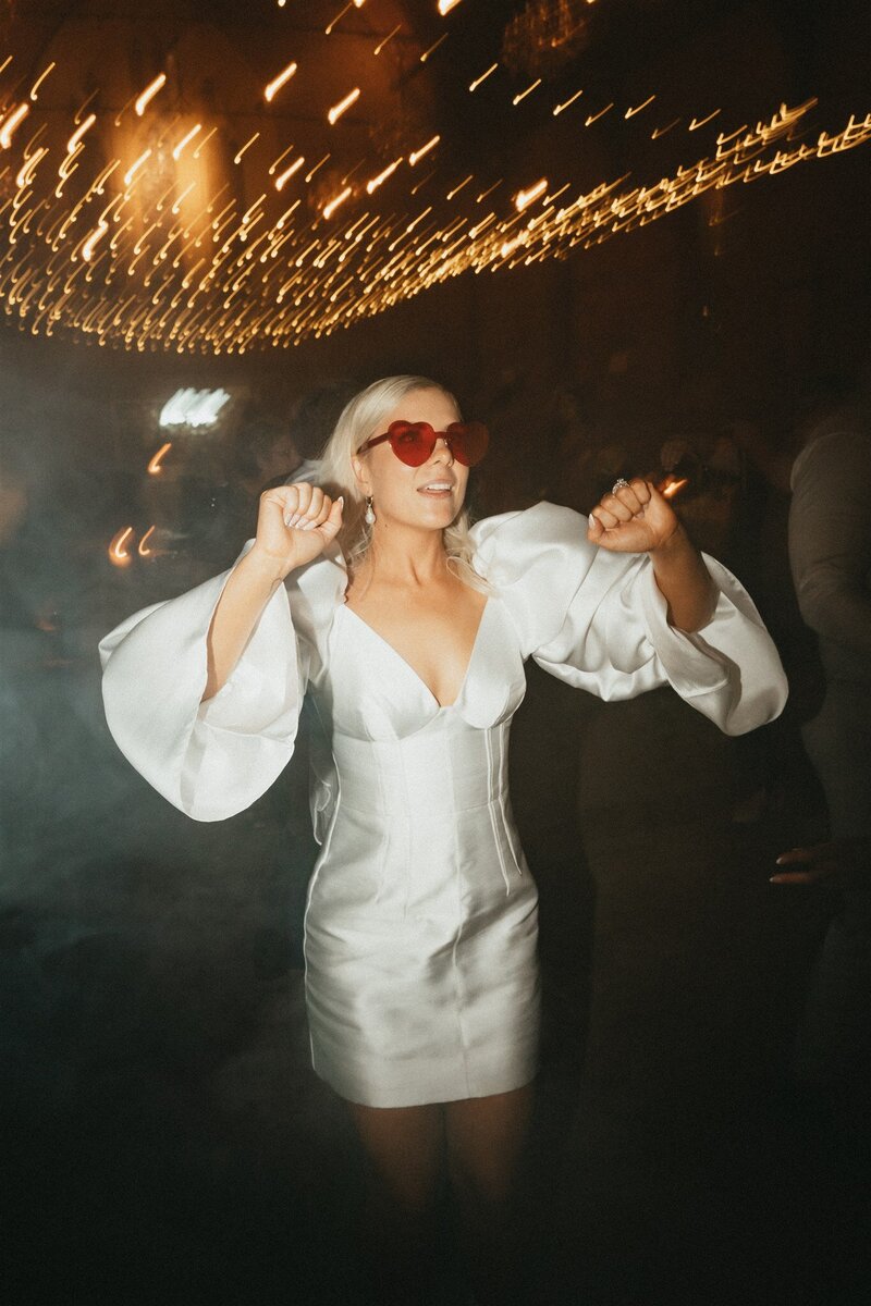 Bride with heart eye glasses dancing at her Newcastle wedding
