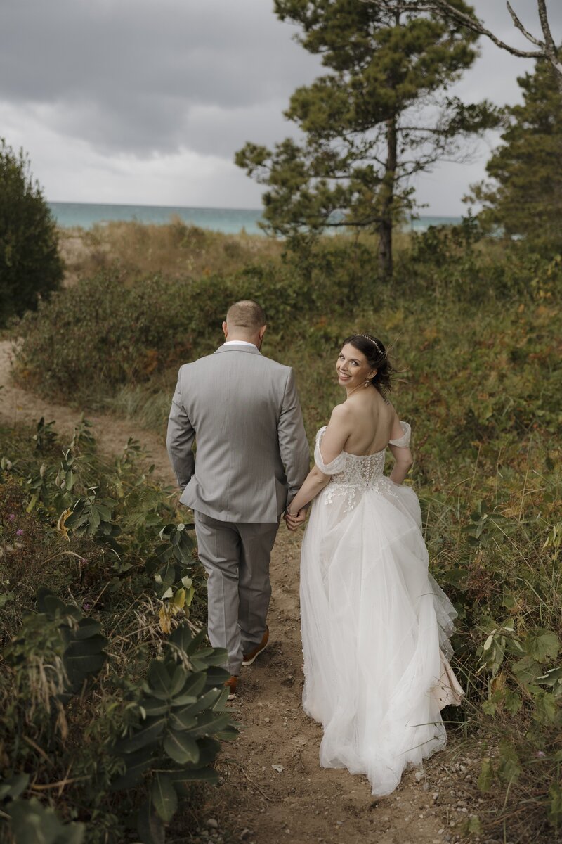 bride and groom walking away from camera