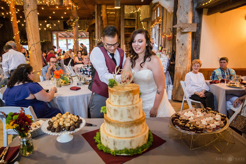 Cake Cutting inside rustic Colorado barn wedding venue