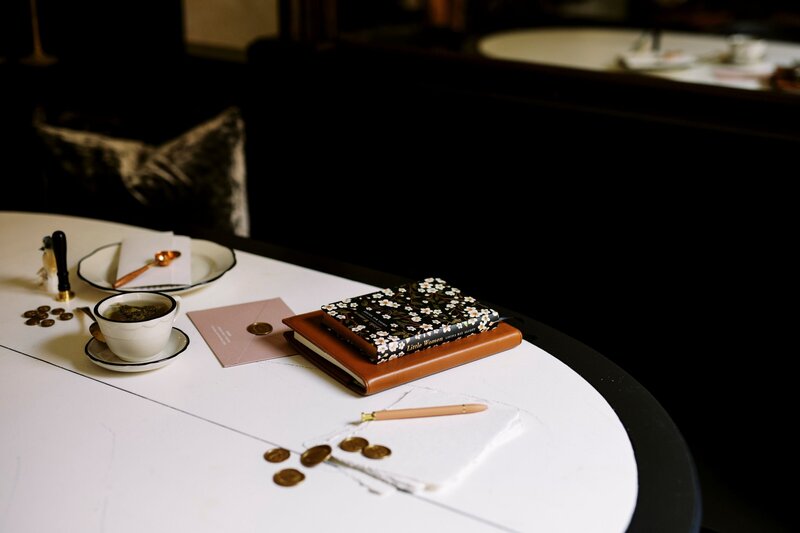 notebook and wax seal stamps on table