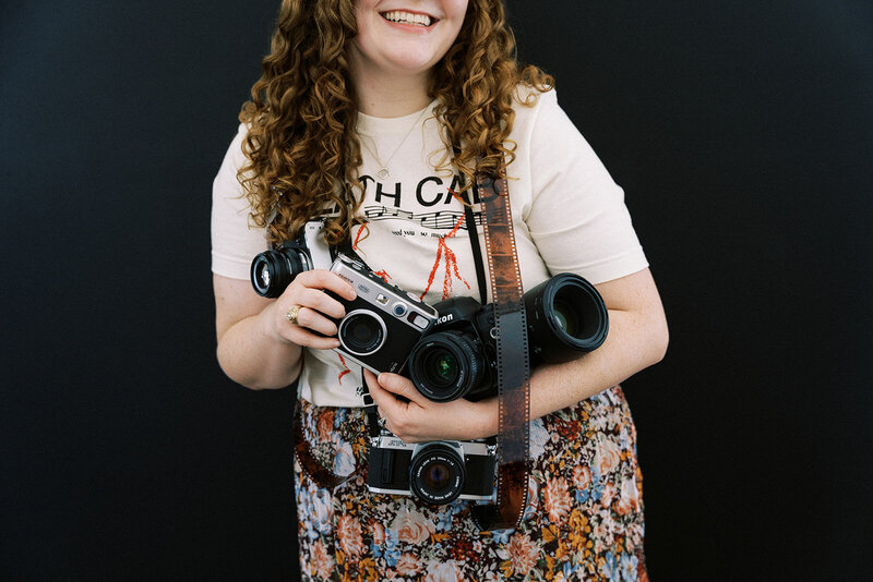 Allison Bolin Texas wedding photographer holding digital and film cameras