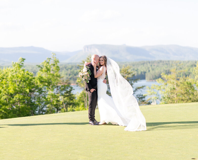 bride and groom posing on golf course