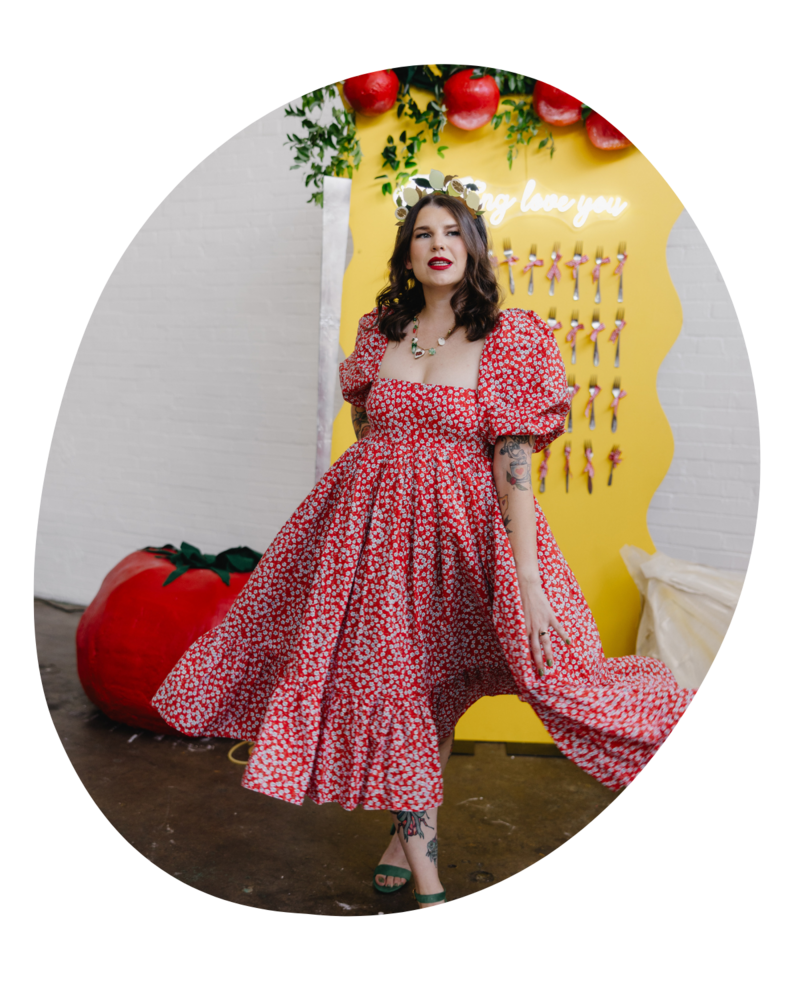 Taylor, lead floral designer and founder of The Floral Eclectic, smiling in her Dallas studio surrounded by colorful blooms and creative floral installations.